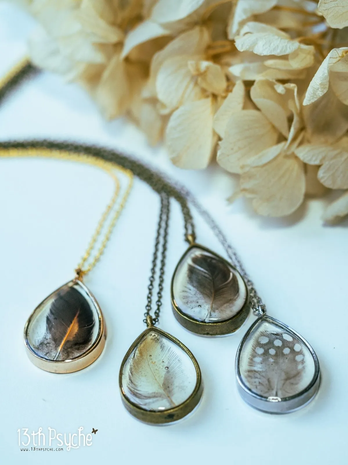 Drop shaped resin pendant with real feather necklace